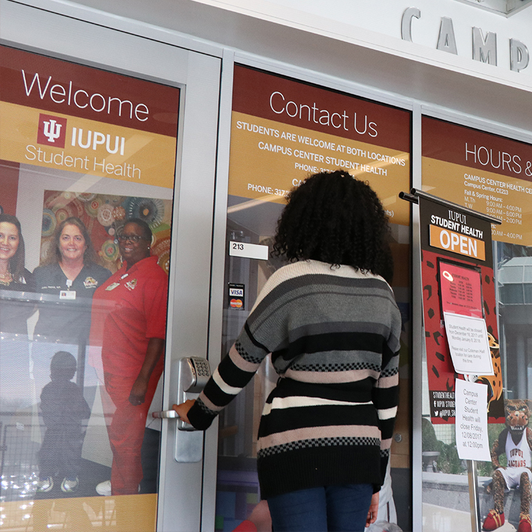 Student opens the door to Campus Center Student Health.